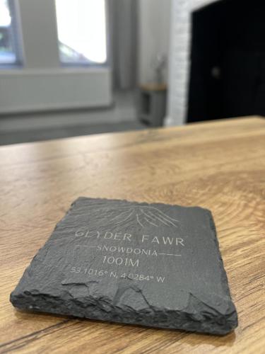 a black napkin sitting on top of a wooden table at Sparkling Space - Twin or King Beds in Bangor