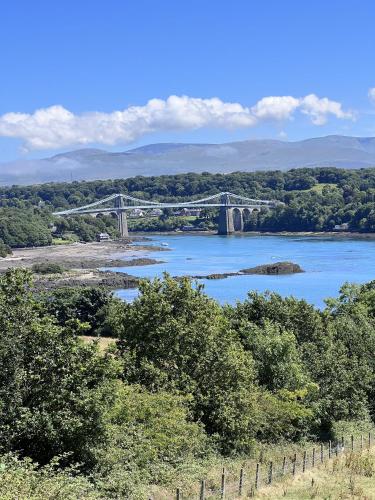a bridge over a river with a bridge in the distance at Sparkling Space - Twin or King Beds in Bangor