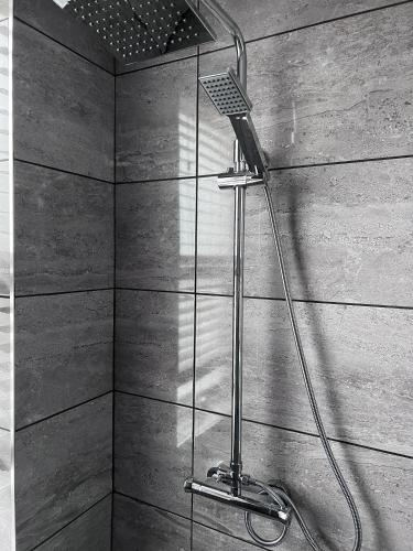 a shower with a shower head in a bathroom at Sparkling Space - Twin or King Beds in Bangor