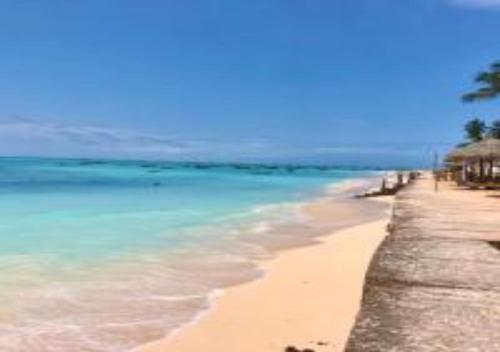 a beach with a pier and the ocean at Magharibi House in Nungwi