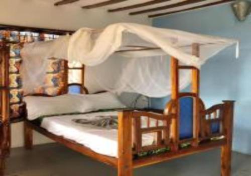 a bedroom with a bunk bed with a canopy at Magharibi House in Nungwi
