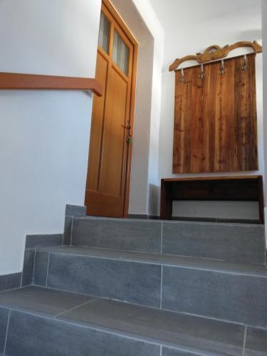 a set of stairs with a door and wooden doors at Erlhofer Apartments in Tröpolach