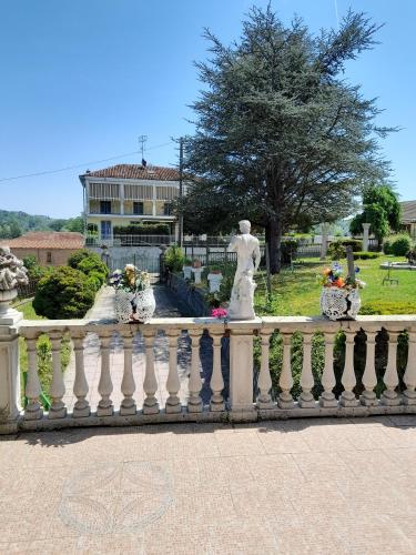 a white railing with a statue in a park at Da Betty in Asti
