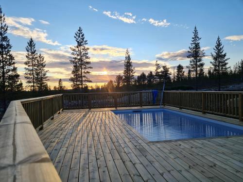 a deck with a swimming pool on top of a house at Poolorama Lodge - with magnificent mountain view in Idre