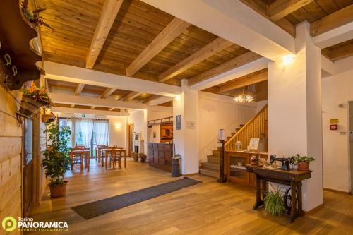 a large living room with wooden ceilings and wooden floors at Locanda Aquila Bianca in Valprato Soana