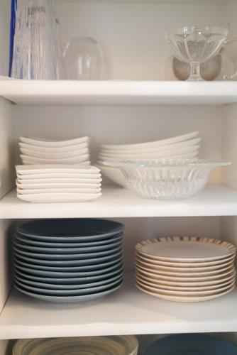 a stack of plates and bowls on a shelf at 桔恭(KIKYO) in Otaru