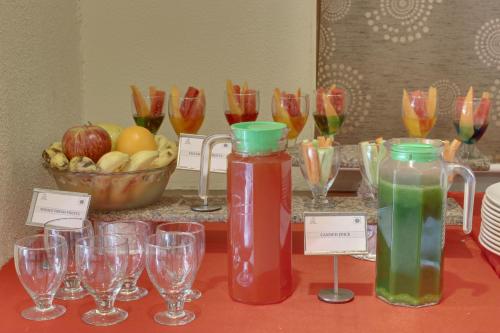 a table with two bottles and glasses on a table at The Royal Melange Beacon in Ajmer