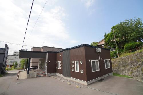 a large brown building with white numbers on it at 桔恭(KIKYO) in Otaru