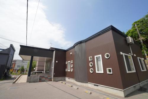 a building with a brown on a street at 桔恭(KIKYO) in Otaru