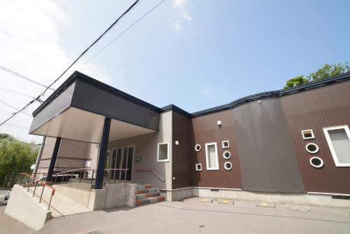 a building with a black roof and a building at 桔恭(KIKYO) in Otaru
