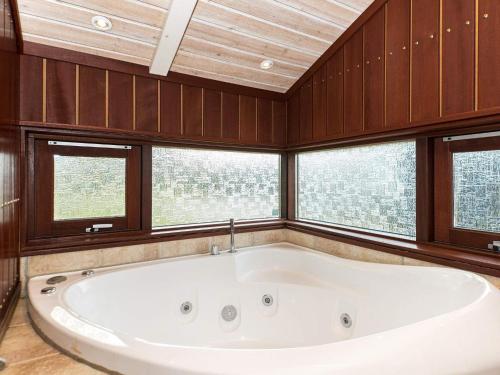 bañera grande en una habitación con ventanas en 8 person holiday home in Glesborg, en Glesborg