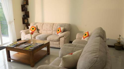 a living room with a couch and a coffee table at Amandara Hills Kandy in Kandy