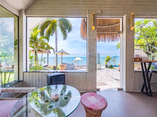 a dining room with a table and a view of the ocean at Sea Valley Resort in Lipa Noi