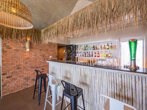 a bar with two chairs and a counter with drinks at Sea Valley Resort in Lipa Noi