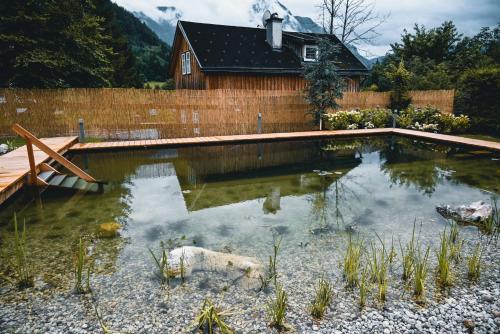 a pool of water in front of a house at Landhaus Alte Salzstraße - Your Austrian Home in Bad Aussee