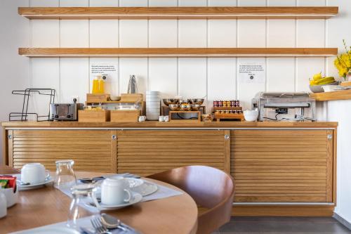 a kitchen with a table and a counter at Olia Green Residence in Skopelos Town