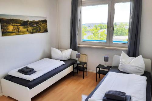 Posteľ alebo postele v izbe v ubytovaní Apartments Halle West