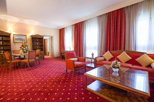 a living room with a couch and a table at Capitol Hotel Jumeirah Dubai in Dubai