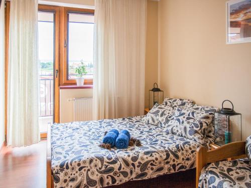 Un dormitorio con una cama con zapatos azules. en Willa Piano en Krynica Morska