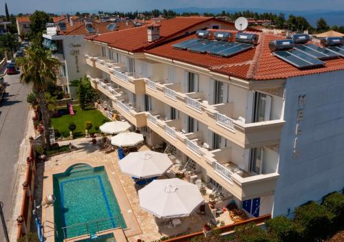 an aerial view of a hotel with a swimming pool and umbrellas at Melis Studios in Kallithea Halkidikis