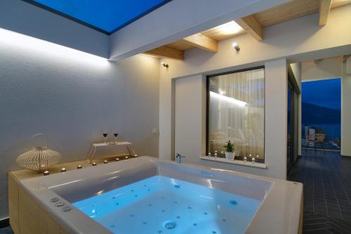 a large tub in a room with a window at Selin Luxury Residences in Ioannina