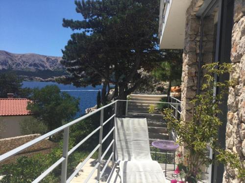 a balcony with stairs and a view of the water at Shimmer & Shine in Baška