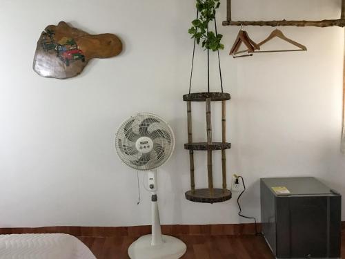 a room with a fan on a wall at Cabaa Type Glamping - with swimming pool in Rizaralda