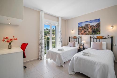 Ένα ή περισσότερα κρεβάτια σε δωμάτιο στο Villa Jimena by Mabiente