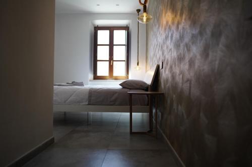 a bedroom with a bed and a window at Gallurasuite in Luras