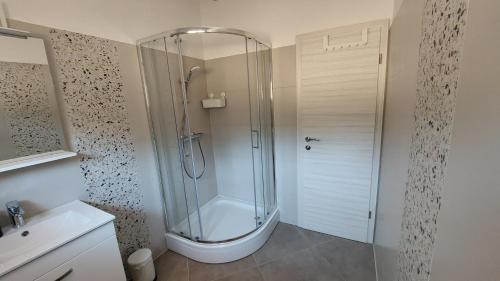 a bathroom with a shower with a toilet and a sink at Apartments Dora, with a beautiful view of the bay, near the sea and center in Vrboska