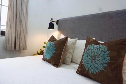 a bedroom with a bed with pillows on it at Papilio Homestay Tay Ho in Hanoi