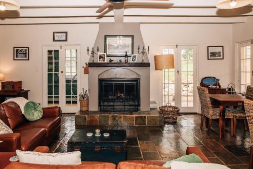 a living room with a couch and a fireplace at Hope Farm Guesthouse in York