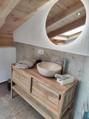 a bathroom with a bowl sink on a wooden counter at Chiemseehof in Prien am Chiemsee