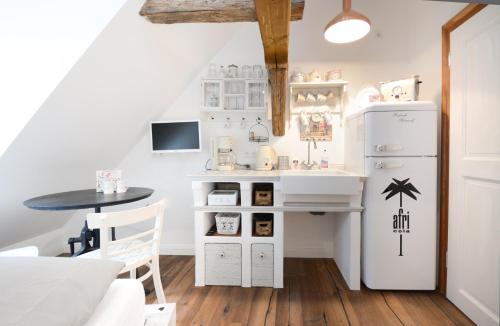 a kitchen with a small table and a refrigerator at Schlafstube Bamberg in Bamberg