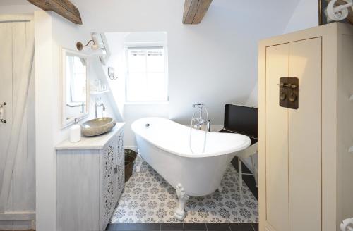 a bathroom with a white tub and a sink at Schlafstube Bamberg in Bamberg