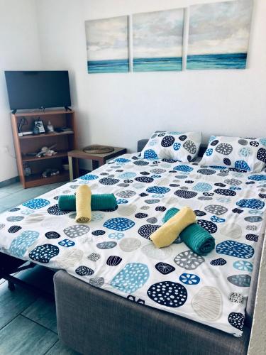 a bed with blue and white pillows on it at Lovely studio apartment Mare e Sole in Labin