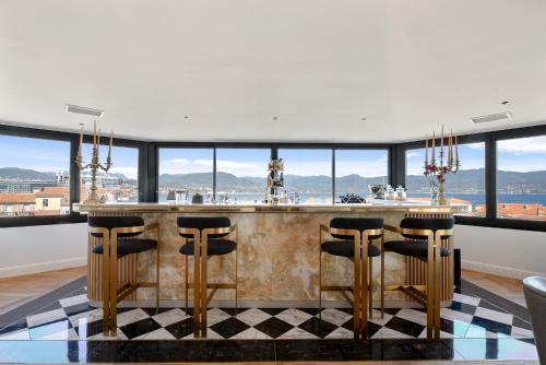 a kitchen with a bar with a view at Hotel San Carlu Citadelle Ajaccio in Ajaccio
