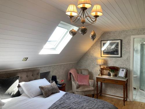 a bedroom with a bed and a skylight at Ivy Cottage B&B in Killarney