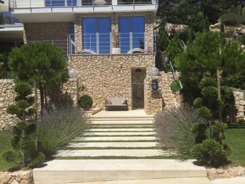 a house with a staircase leading to the front door at Shimmer & Shine in Baška