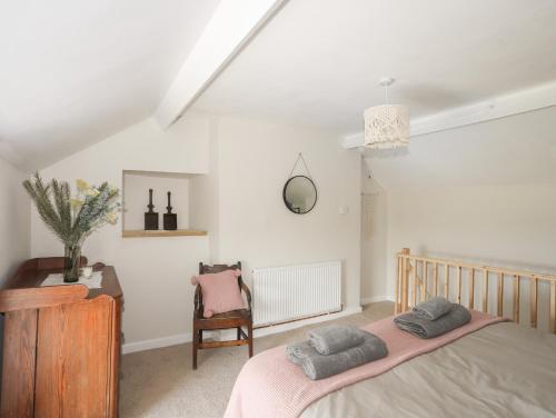 a bedroom with a bed and a chair at Cwm Ceiliog Annex in Caernarfon