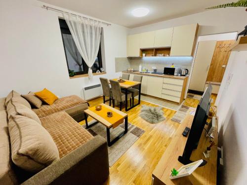 a living room with a couch and a table at Apartmani Vojinović in Zlatibor