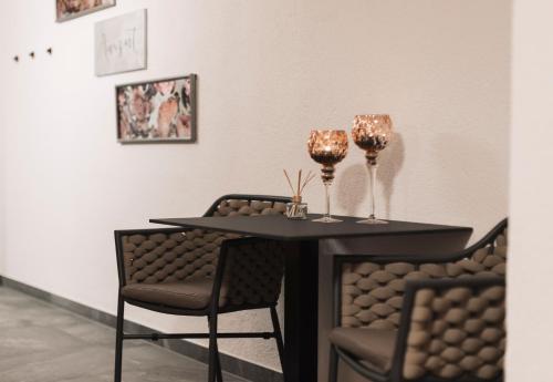 a table with two wine glasses on top of it at Apart Al-Aviöler in Ischgl