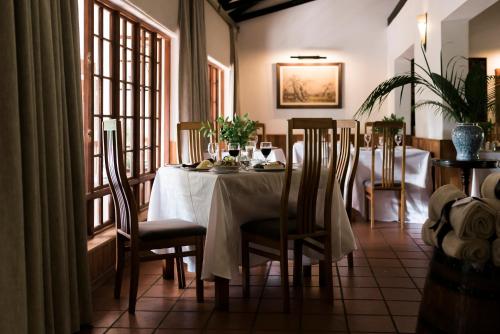 a dining room with a table with a white table cloth at Tzaneen Country Lodge in Tzaneen