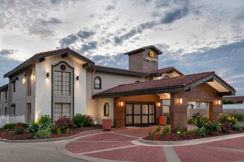 a large white building with a clock tower on top at La Quinta Inn by Wyndham Columbus Airport Area in Columbus