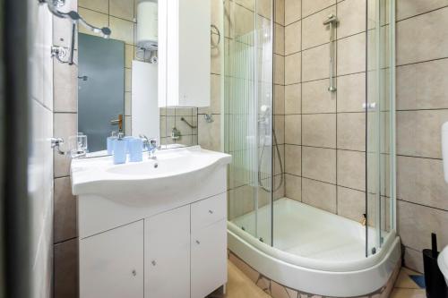 a bathroom with a sink and a shower at Secret Rooms in Rovinj