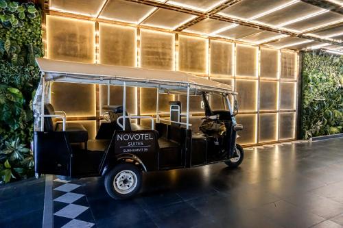 a golf cart is parked in a building at Novotel Suites Sukhumvit 39 in Bangkok