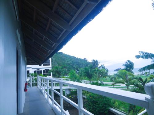 a balcony of a house with a view of the ocean at MG Chateau Resort in El Nido