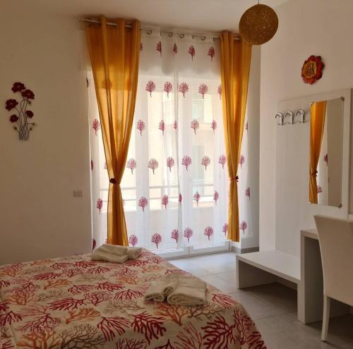 a bedroom with a bed and a large window at Melody Rooms in Soverato Marina
