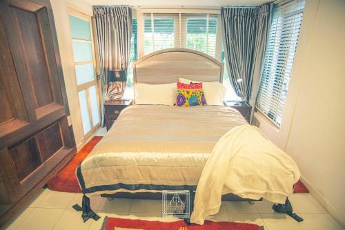 a bedroom with a large bed in a room at Baan Suan Residence เฮือนพักบ้านสวน in Chiang Mai