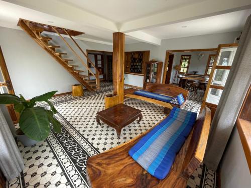 a room with two beds and a spiral staircase at Villa Secret Garden Kep-Panoramic view-WI-FI in Phumĭ Prey Srâmaôch